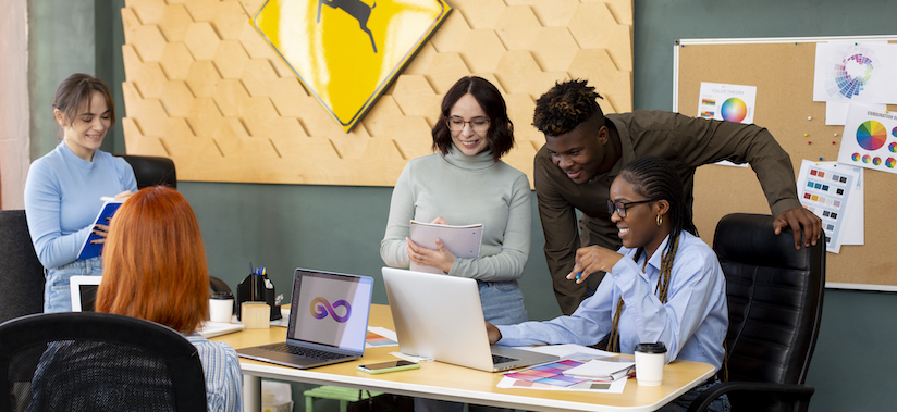 Agile Workforce: An image representing a diverse group of professionals collaborating in a modern office setting, symbolizing the agility and adaptability of a skills-first approach