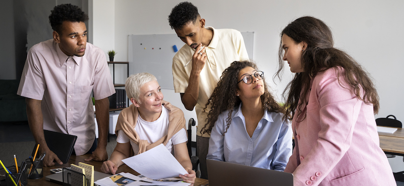 Inclusive Work Environment: An image showing a team of employees from diverse backgrounds working together harmoniously, representing the inclusivity fostered by a skills-first approach